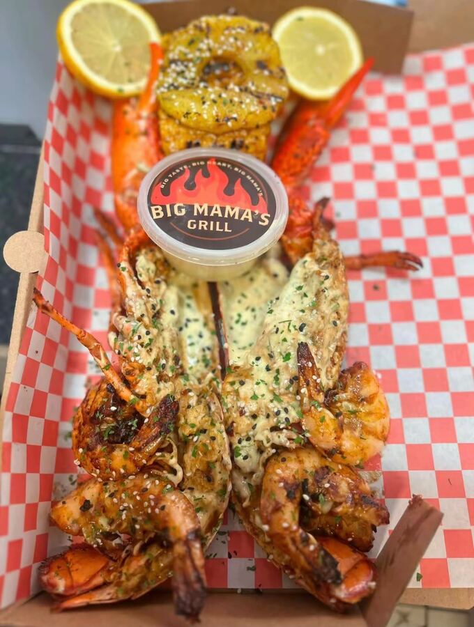 Grilled lobster with garlic butter, prawns and lemon