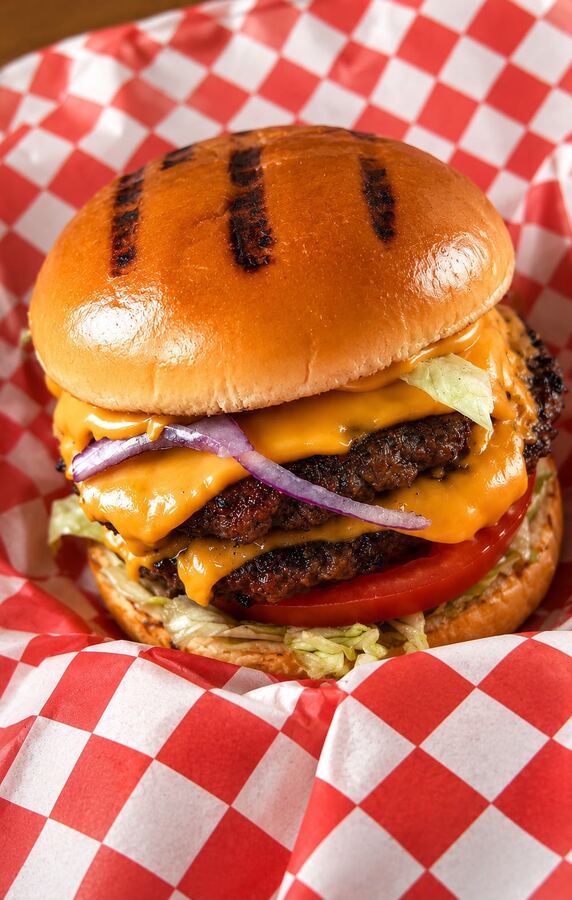 Smash burger with melted cheese, lettuce, tomato and red onion